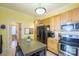 Bright kitchen with wood cabinets, stainless steel appliances, and an island at 402 W 7Th St, Newton, NC 28658