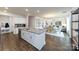 Open kitchen with island, hardwood floors, and white cabinets at 4356 Bronze Blvd, Sherrills Ford, NC 28673