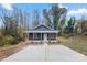 Quaint house exterior with gray siding and a covered front porch at 519 Westside Cir, China Grove, NC 28023