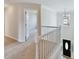 Upstairs hallway with carpeted floors and access to bedrooms at 129 Coronilla Rd, Mooresville, NC 28117