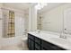 Bathroom with double sinks, dark vanity, and bathtub at 2524 Wellshire Ct, Gastonia, NC 28056