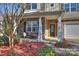 Inviting front porch with stone columns, landscaping, and seating area at 2524 Wellshire Ct, Gastonia, NC 28056