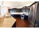 Modern kitchen with dark cabinetry and stainless steel appliances at 2524 Wellshire Ct, Gastonia, NC 28056