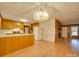 Dining area with hardwood floors, brick fireplace, and kitchen view at 3113 Old Pageland Marshville Rd, Wingate, NC 28174