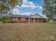 Brick ranch home with covered porch, large yard, and detached garage at 3113 Old Pageland Marshville Rd, Wingate, NC 28174