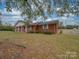 Brick ranch house with covered porch and mature trees at 3113 Old Pageland Marshville Rd, Wingate, NC 28174