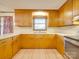 L-shaped kitchen with wood cabinets, double sink, and stainless steel oven at 3113 Old Pageland Marshville Rd, Wingate, NC 28174