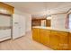 Kitchen boasts wood cabinets, an island, and stainless steel dishwasher at 3113 Old Pageland Marshville Rd, Wingate, NC 28174