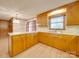 Bright kitchen features wood cabinets, stainless steel appliances, and light wood flooring at 3113 Old Pageland Marshville Rd, Wingate, NC 28174