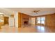Living room with brick fireplace, wood paneling, and hardwood floors at 3113 Old Pageland Marshville Rd, Wingate, NC 28174