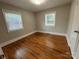 Well-lit bedroom featuring hardwood floors and window blinds at 3427 Eastway Dr, Charlotte, NC 28205