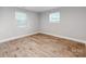 Simple bedroom with wood-look floors and two windows at 615 Stirewalt St, China Grove, NC 28023