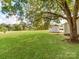 Large backyard with green grass and mature trees at 615 Stirewalt St, China Grove, NC 28023