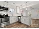 Open kitchen with island, stainless steel appliances, and white cabinets at 647 Simpson St, Rock Hill, SC 29730