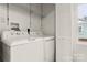 White washer and dryer in a well-lit laundry room with storage at 647 Simpson St, Rock Hill, SC 29730
