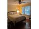 Cozy bedroom with hardwood floors and a ceiling fan at 7313 Leacroft Ct, Charlotte, NC 28226