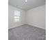 Spacious bedroom featuring carpeted floors and a large window with blinds at 913 Smithcliffs Trl, York, SC 29745