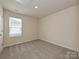 Simple bedroom with carpeted floor, window with blinds, and neutral wall colors at 913 Smithcliffs Trl, York, SC 29745
