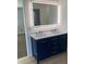 Double vanity bathroom with a lighted mirror and blue cabinets at 107 Monterey Dr, Mooresville, NC 28117