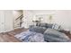 Living area with sectional sofa, hardwood floors and view of staircase at 2016 Tupelo Grove Ln, Gastonia, NC 28054