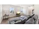 Living room featuring a sectional sofa, hardwood floors, and large windows at 2016 Tupelo Grove Ln, Gastonia, NC 28054