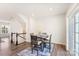 Bright dining area with table and chairs, hardwood floors, and access to upper level at 2016 Tupelo Grove Ln, Gastonia, NC 28054