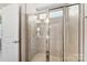 Bathroom featuring a shower stall with glass door and neutral tile at 2016 Tupelo Grove Ln, Gastonia, NC 28054