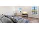 Spacious living room with gray sectional sofa and large windows at 2016 Tupelo Grove Ln, Gastonia, NC 28054