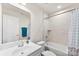 Bathroom with tub shower combination, white vanity, and a modern feel at 2016 Tupelo Grove Ln, Gastonia, NC 28054