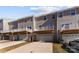 Rear view of townhomes with private decks and garages at 2016 Tupelo Grove Ln, Gastonia, NC 28054