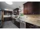 Updated kitchen with dark wood cabinets, granite countertops, and farmhouse sink at 3092 Lee Lawing Rd, Lincolnton, NC 28092