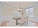 Formal dining room with hardwood floors, chandelier, and large windows at 7215 Firespike Rd, Charlotte, NC 28277