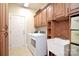 Laundry room with washer, dryer, sink, and ample cabinetry at 7215 Firespike Rd, Charlotte, NC 28277