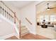 Elegant staircase with wood railing opening to living room at 7215 Firespike Rd, Charlotte, NC 28277