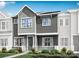 Attractive two-story townhome with gray siding and landscaping at 8928 Connover Hall Ave, Charlotte, NC 28215