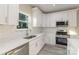 Bright kitchen with white cabinets, quartz countertops, and stainless steel appliances at 1412 10Th St, Statesville, NC 28677