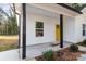 Front porch with black support beams and yellow door at 1412 10Th St, Statesville, NC 28677