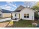 Newly built home with yellow door and small porch at 1412 10Th St, Statesville, NC 28677