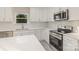 Spacious kitchen boasts white cabinets, quartz countertops and stainless steel appliances at 1412 10Th St, Statesville, NC 28677