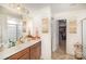 Double vanity bathroom with a walk-in closet and neutral tones at 1628 Savory Ln, Charlotte, NC 28216