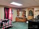 Small bedroom with wood dresser, plaid bedding, and window curtains at 210 Lincoln St, Albemarle, NC 28001