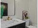 Modern bathroom with marble vanity, gold fixtures, and framed art at 4180 2Nd Ne St, Hickory, NC 28601