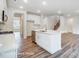 Open concept kitchen with island, stainless steel appliances, and hardwood floors at 5112 Heathland Dr # 75, Charlotte, NC 28215