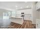 Modern kitchen with white cabinets, island, and stainless steel appliances at 5115 Heathland Dr # 47, Charlotte, NC 28215