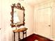 Bright entryway with hardwood floors and an ornate mirror at 5486 Kershaw Camden Hwy, Heath Springs, SC 29058