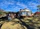 Back exterior view of home with sunroom and yard at 5486 Kershaw Camden Hwy, Heath Springs, SC 29058