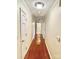 Long hallway with hardwood floors and access to bedrooms and bathrooms at 5486 Kershaw Camden Hwy, Heath Springs, SC 29058