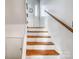 Wooden staircase leading to the upper level of the home at 8905 Longview Dr, Charlotte, NC 28214