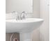 Modern pedestal sink with chrome faucet in a bright bathroom at 10002 Brittondale Ln, Charlotte, NC 28215