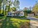 Ranch style home with a red roof, small front porch, and landscaped yard at 22 Henry Ave, Belmont, NC 28012